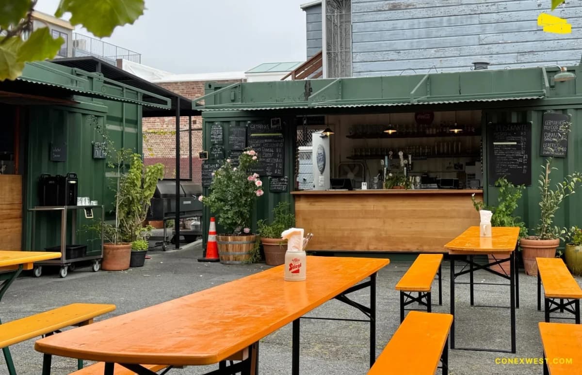 Conex Mike standing in front of Biergarten’s shipping container plaza