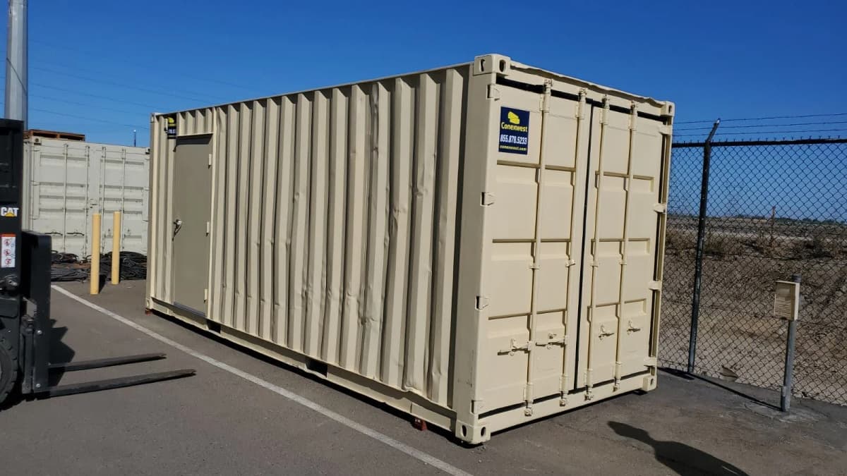 A Conexwest shipping container with a personnel door in its side wall