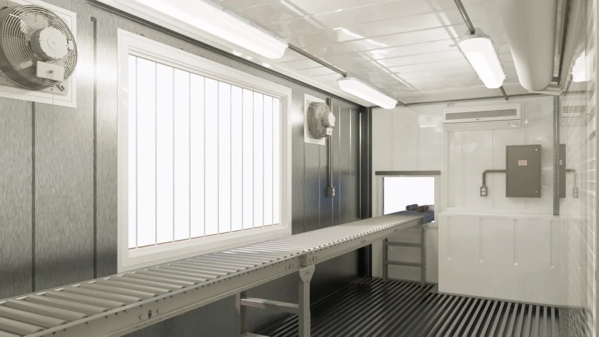 Interior rendering of the CGS MULE core cutting facility with a roller conveyor table, secured window, ventilation fans, lighting, electrical panel, and HVAC