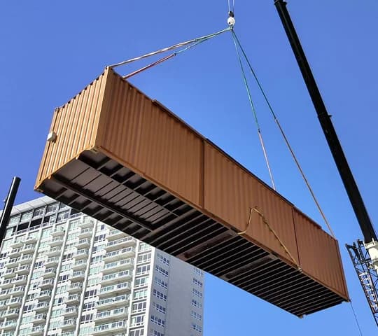 Crane truck placing a shipping container