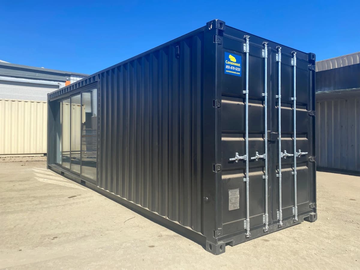 Interior of a custom shipping container storefront with white wall panels and LED lighting