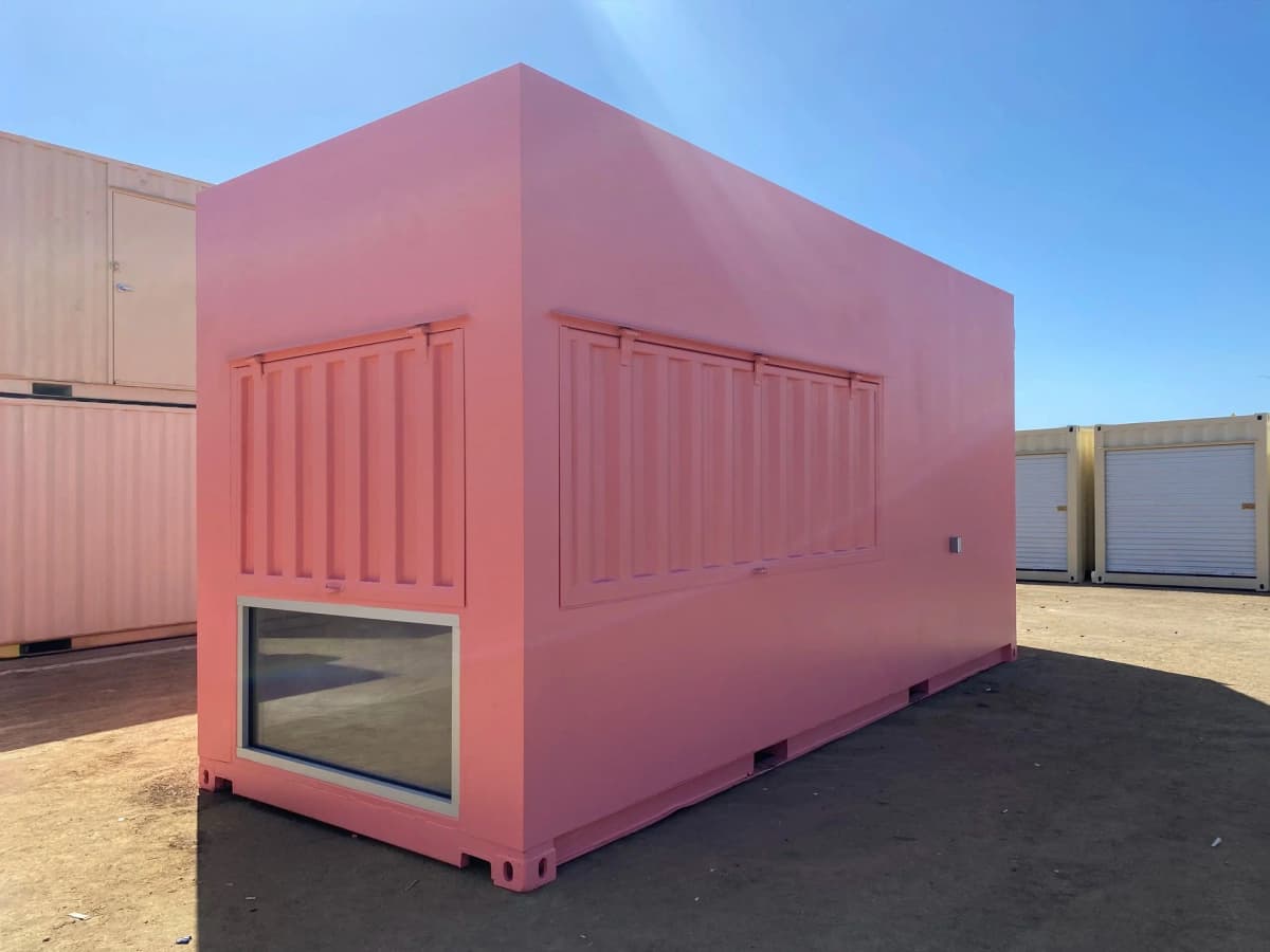 Custom pink container storefront exterior with service awning and smooth side walls