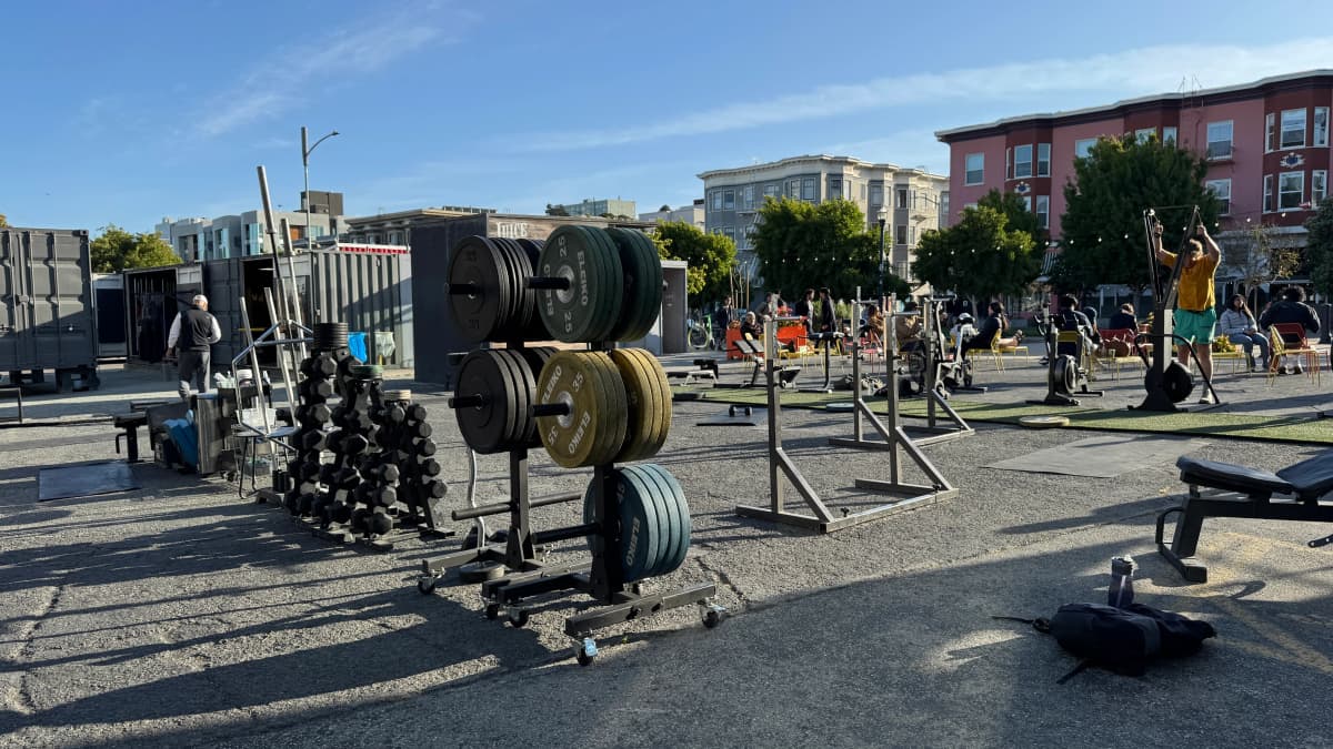 Outdoor workout area at LuxFit with modified shipping containers and fitness equipment