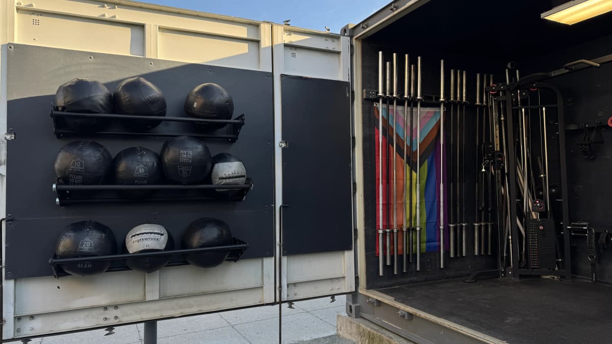 Modified shipping containers supporting the LuxFit open-air gym and community plaza