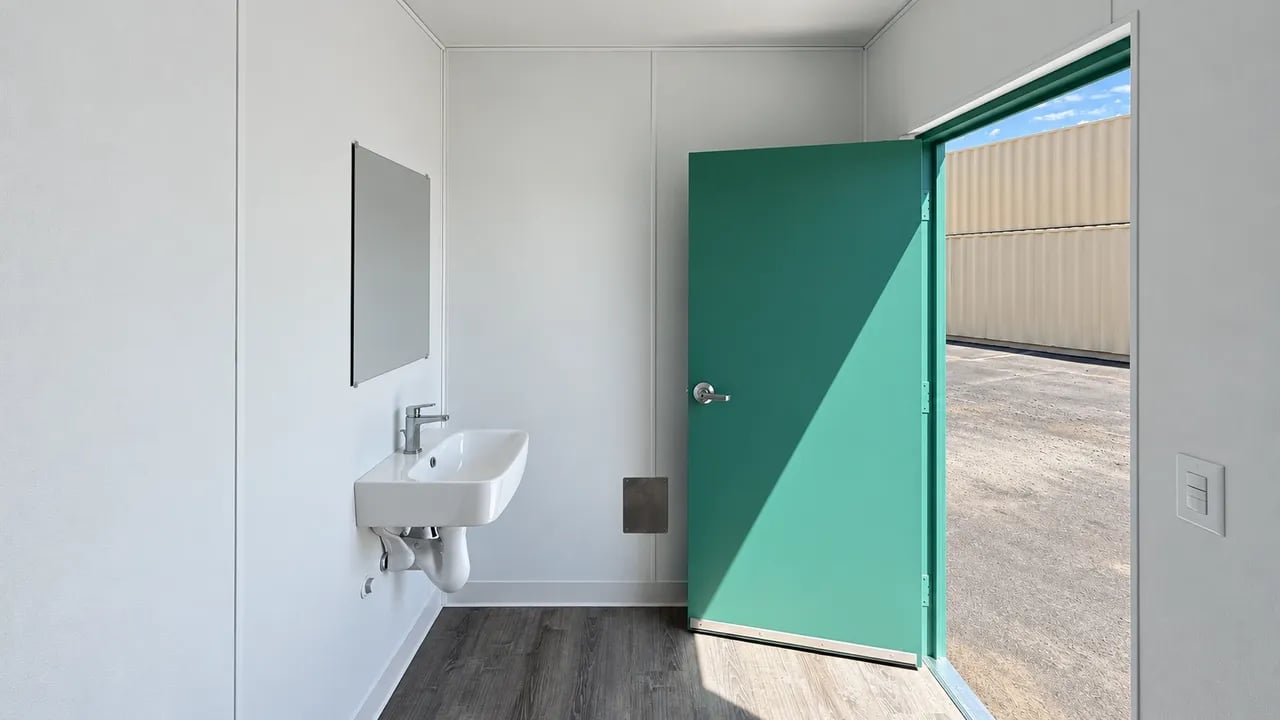 Blue 20ft container with restroom inside