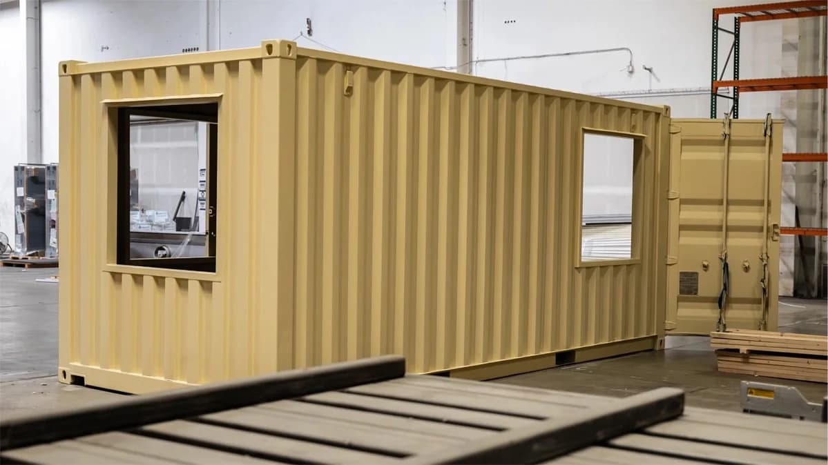 Modified shipping container office with windows in workshop