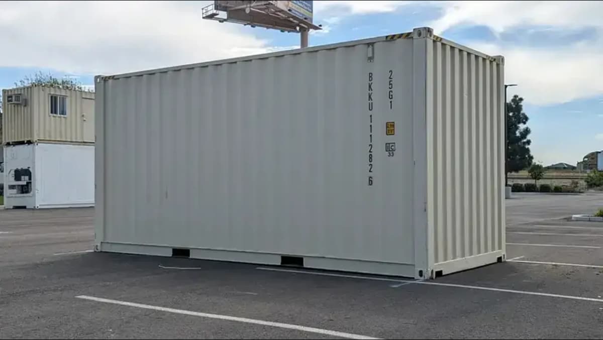 A beige container in a parking lot.