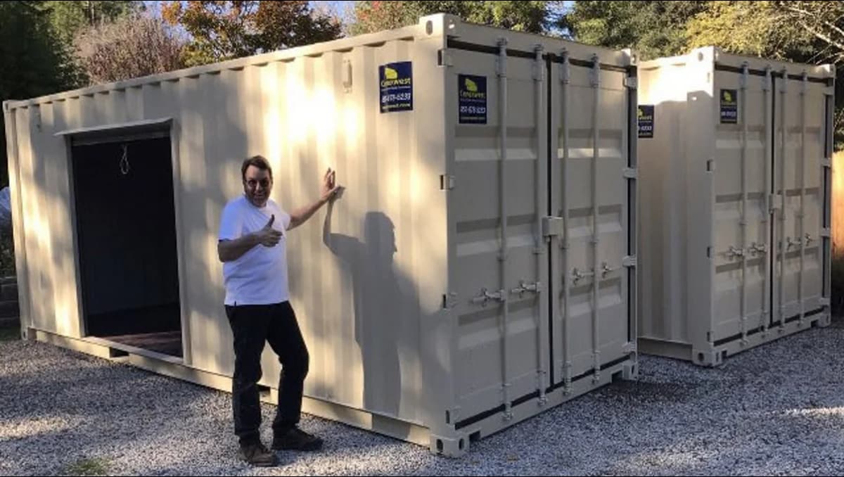 A man beside a shipping container.