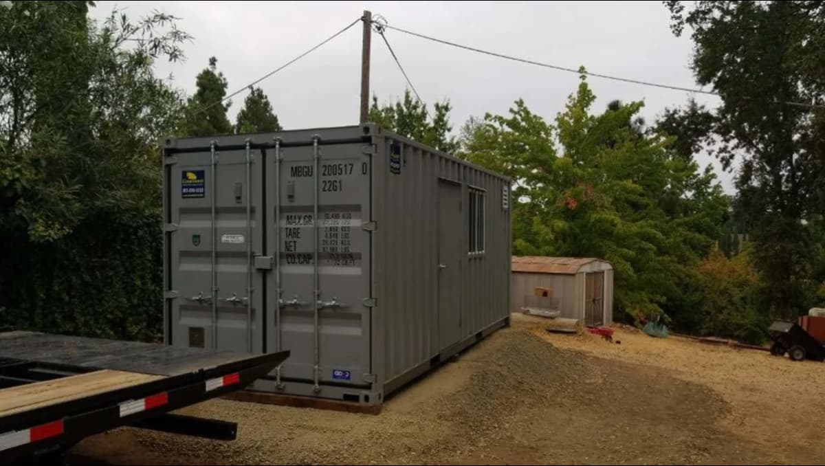 Above-ground shipping container structure as an alternative to full burial