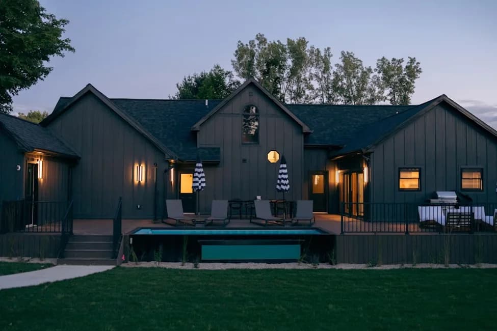 A shipping container house with modern exterior finishes and outdoor living space.