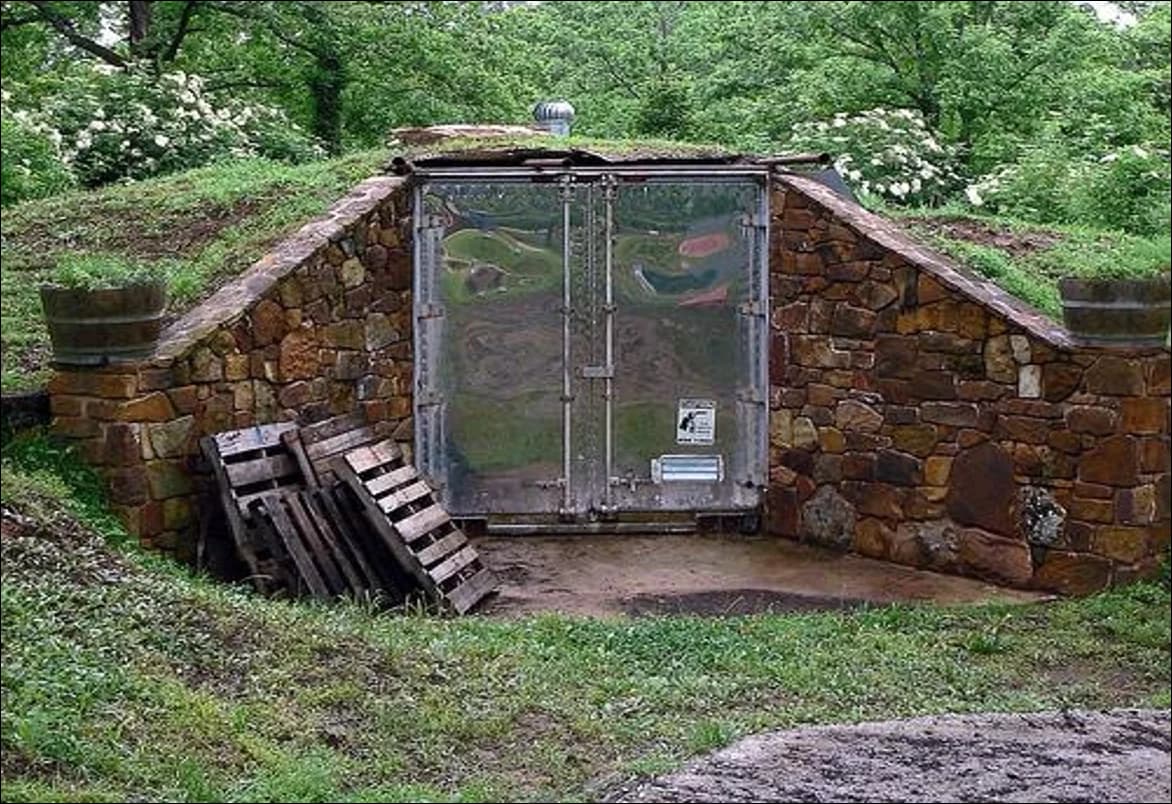Partially buried shipping container storm shelter concept