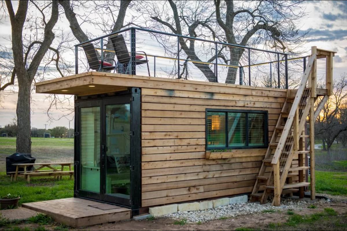A shipping container with wood siding.