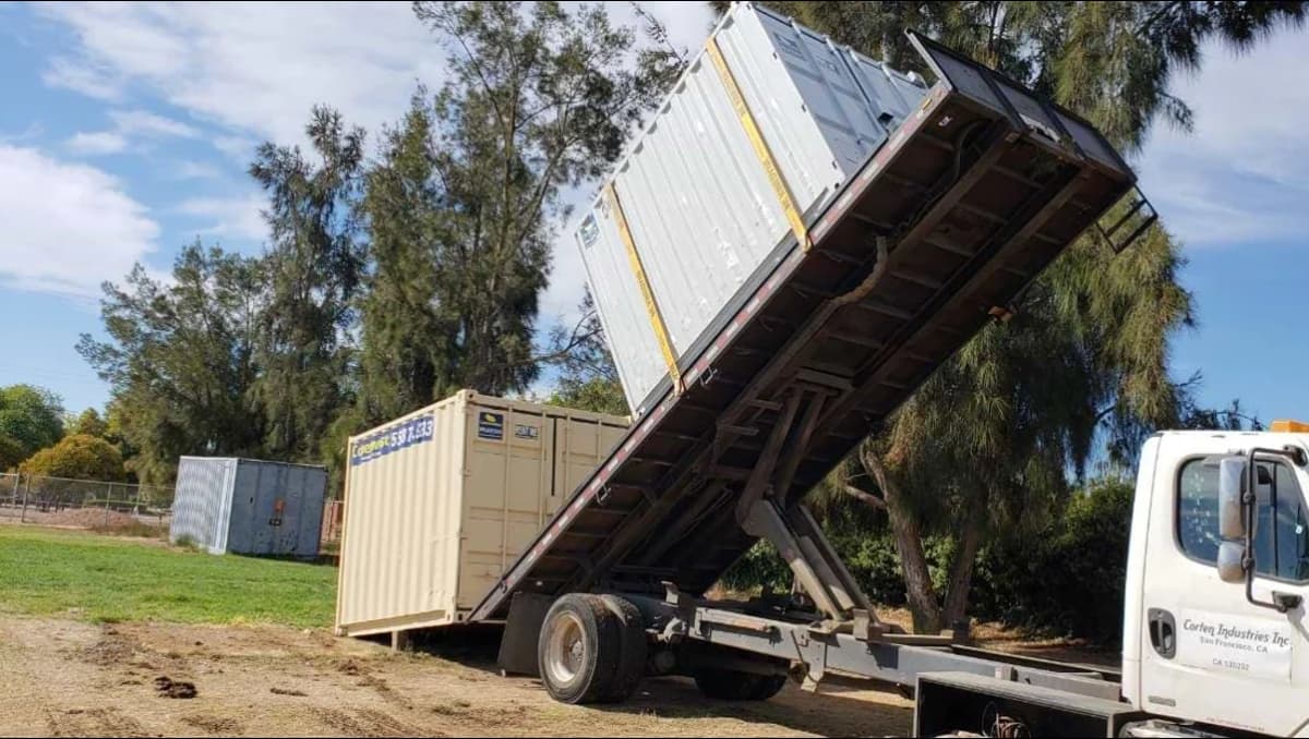 A trailer delivering a container.