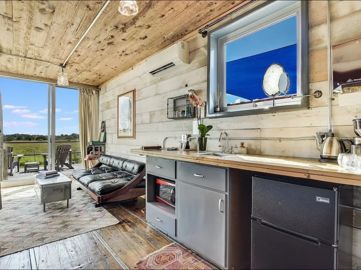 An interior image of a shipping container with siding.