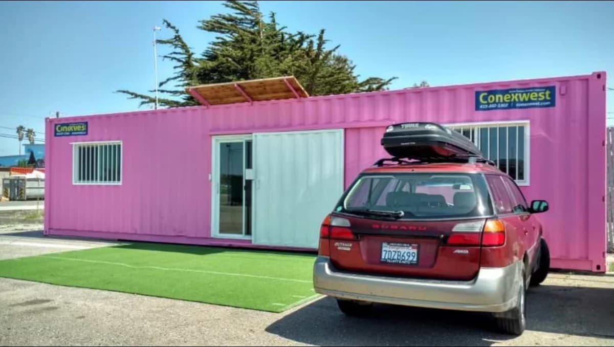 An office container space with a car parked outside.