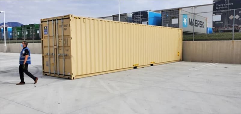 Beige 40-ft shipping container placed in a lot, used for storage or container projects.