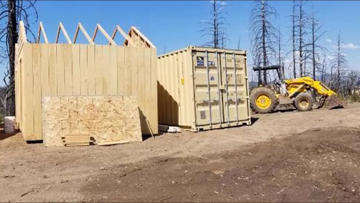 Construction site with a container in the background.