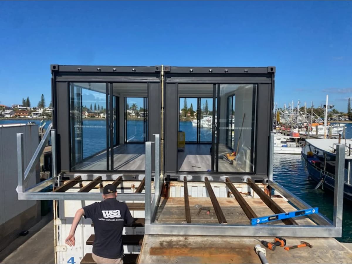 Image of shipping container structure with glass walls.