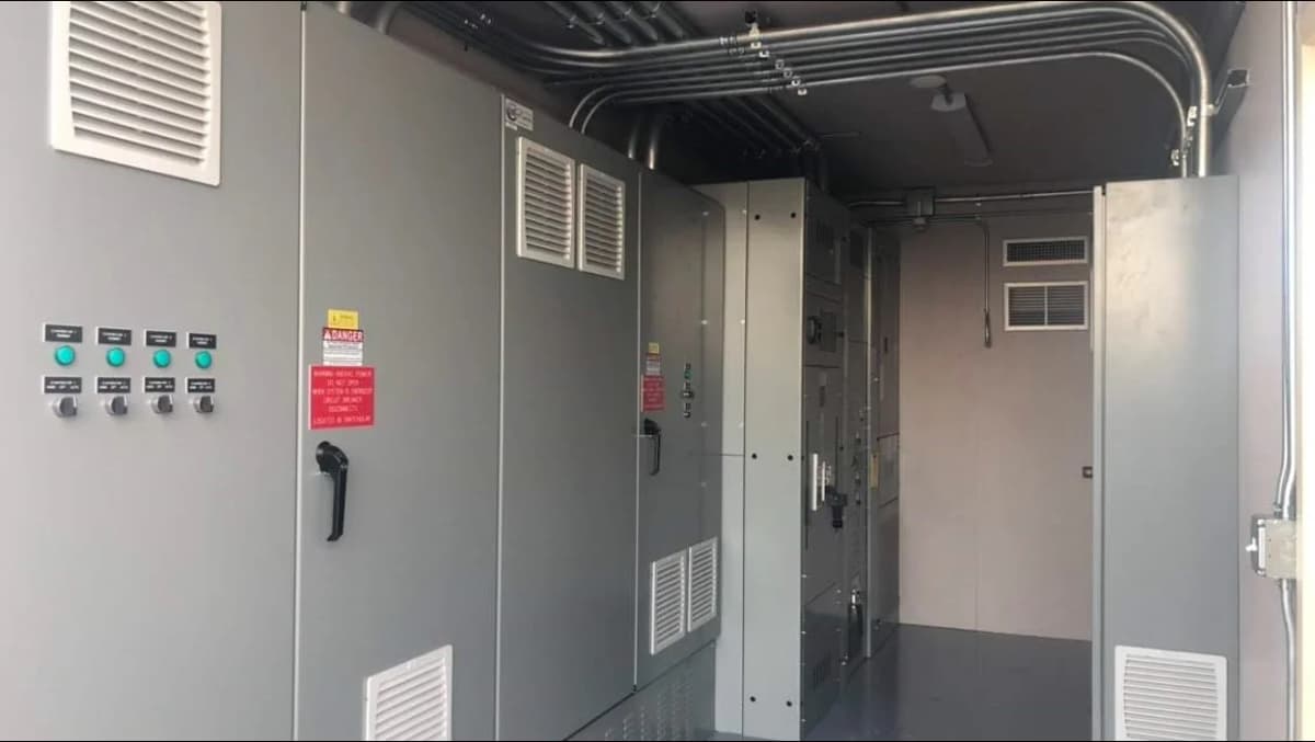 Interior of a modified container bunker showing electrical panels, ventilation, and wiring.