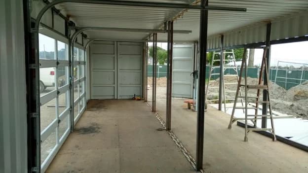 Interior view of a modified shipping container under construction.