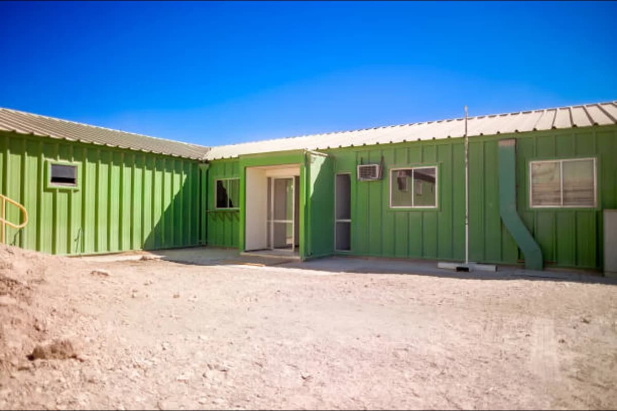 U-shaped container home with central courtyard.