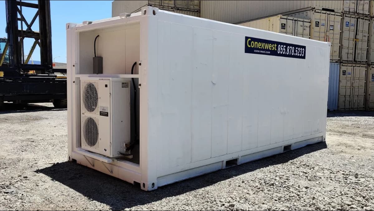 White shipping container with dual external air conditioning units mounted on the side.