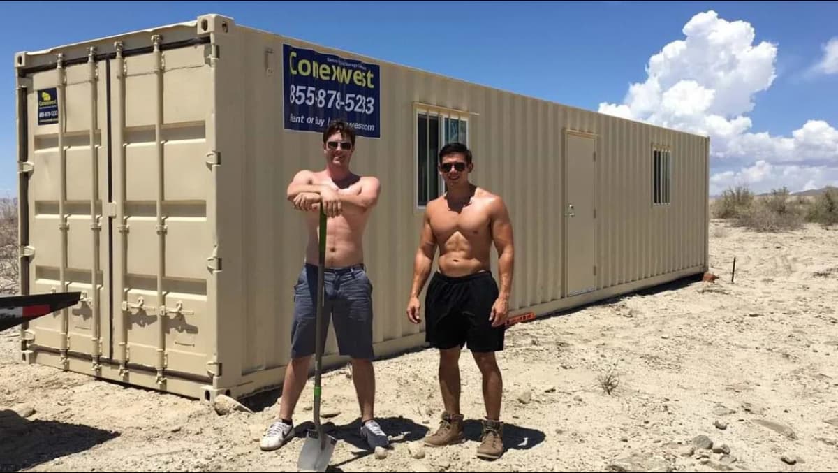 Workers in front of a container
