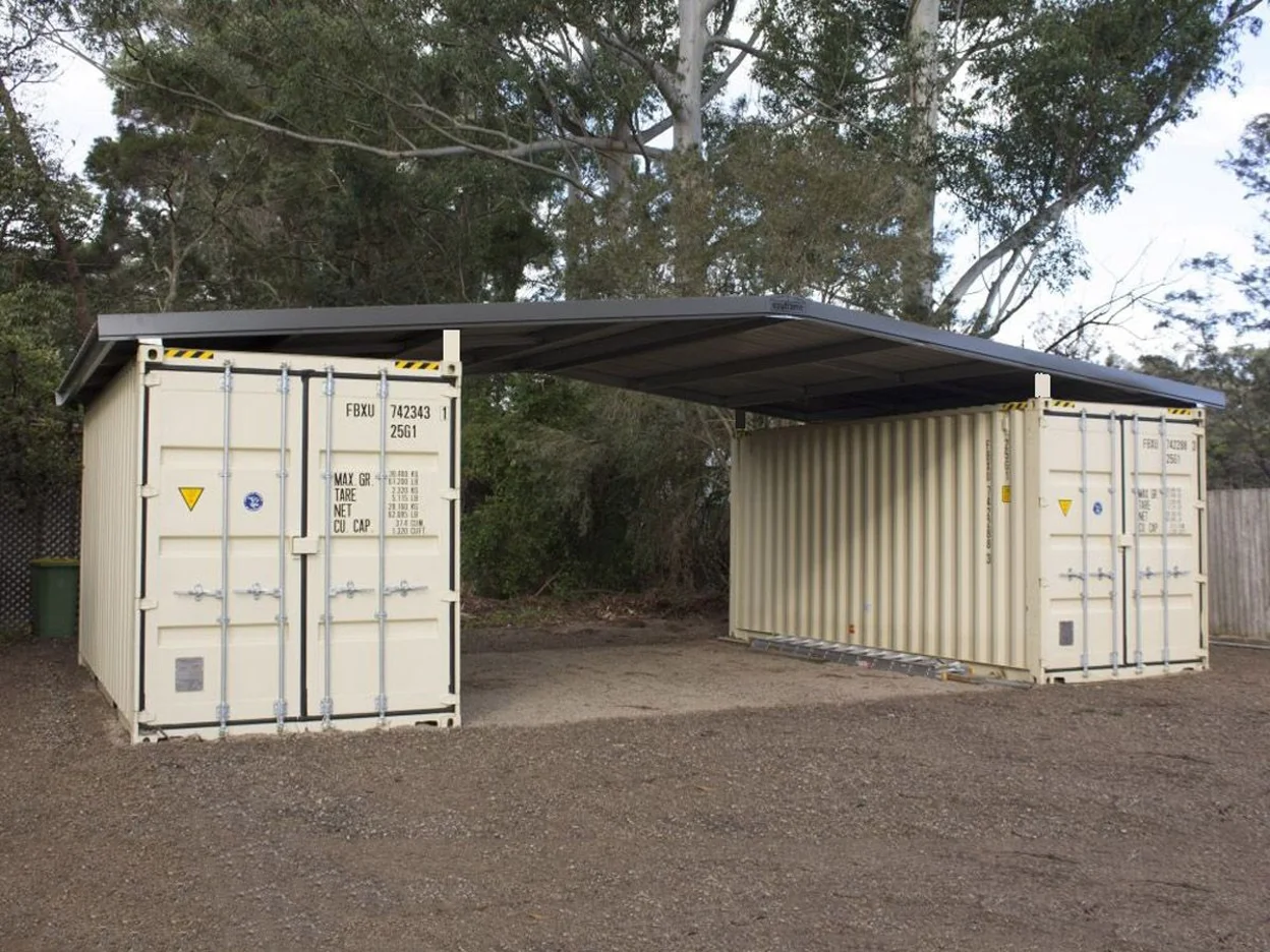 A shipping container with lean-to roofing