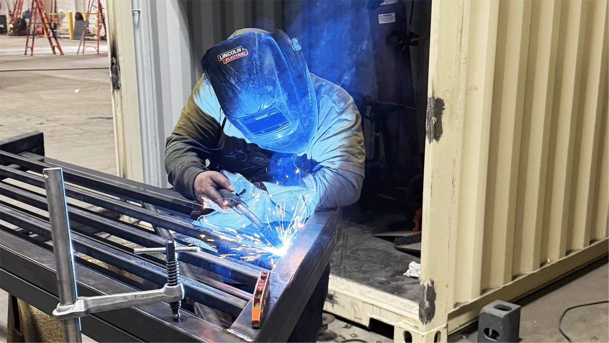Welder working on metal frame