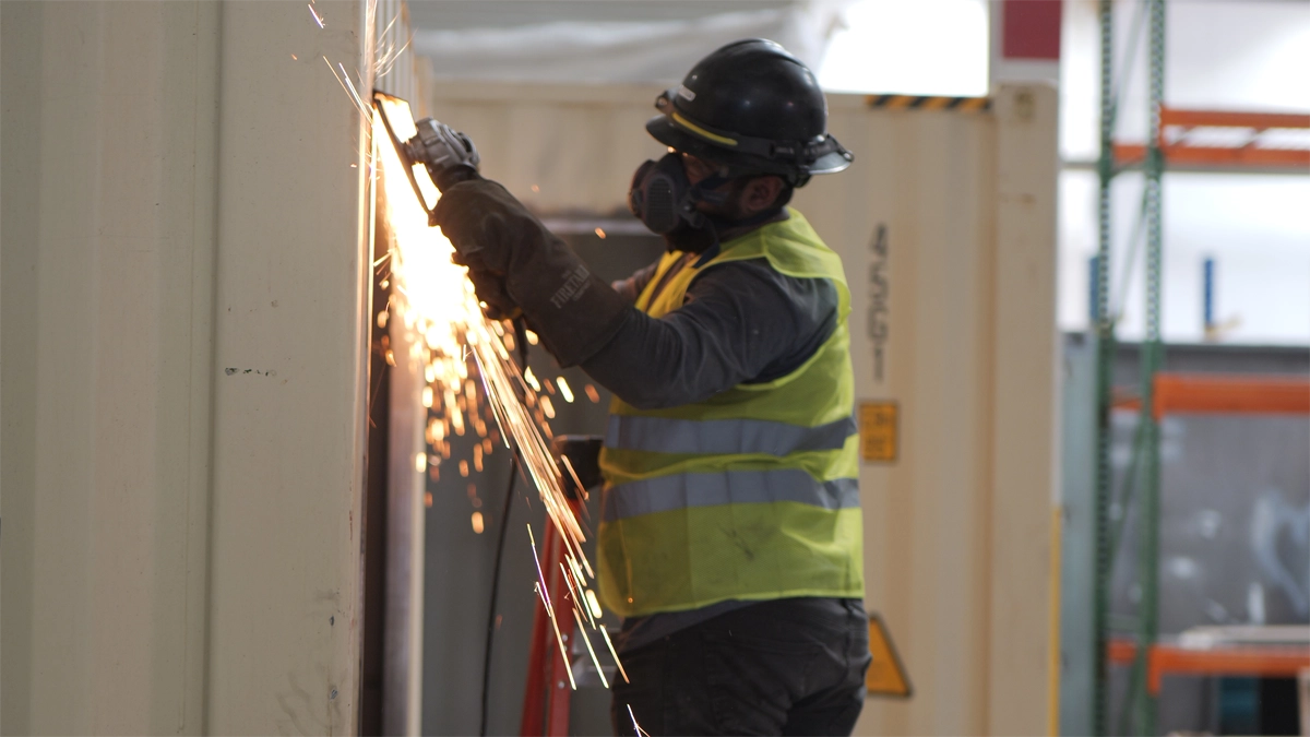 Worker cutting metal panel