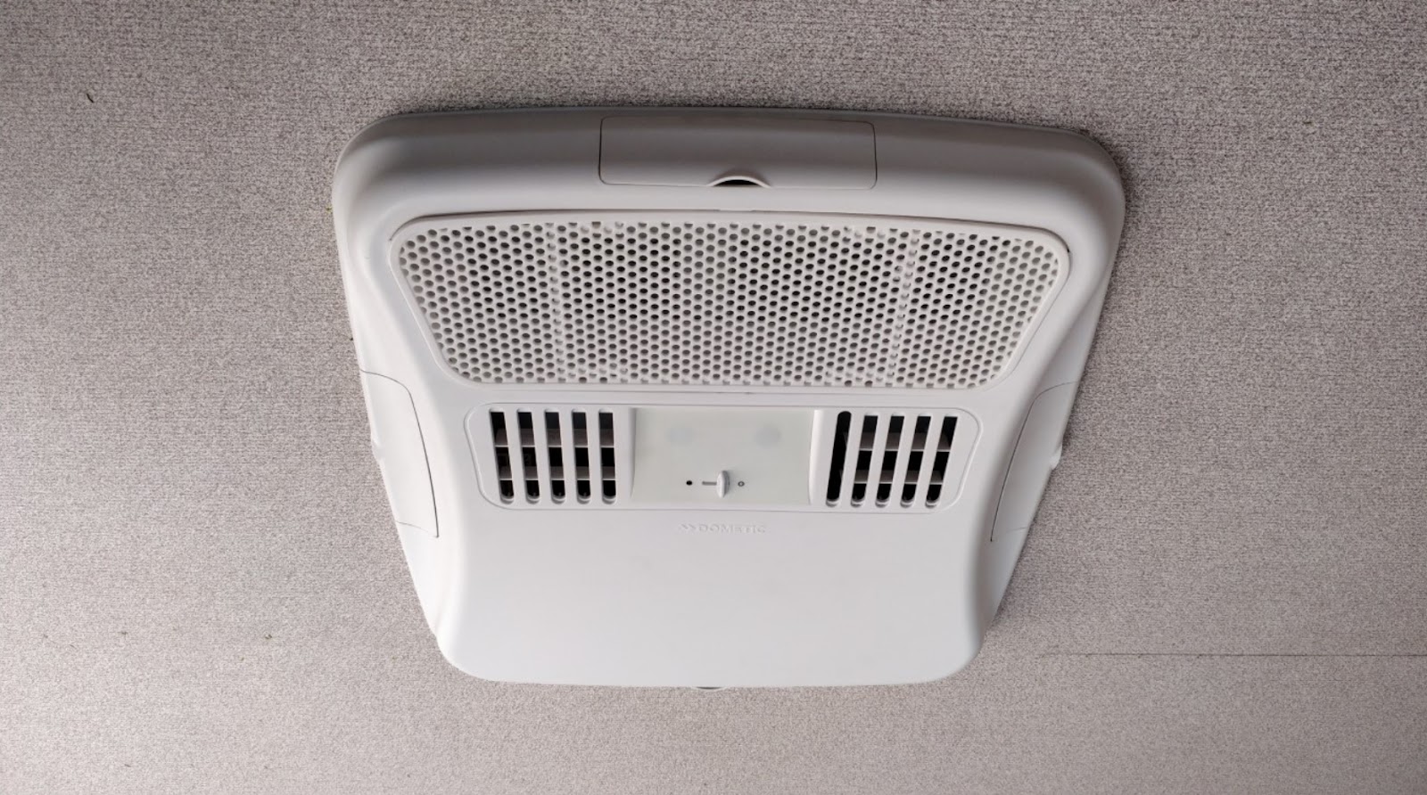 A roof mount air conditioning unit from inside a shipping container, showing how little space it uses 