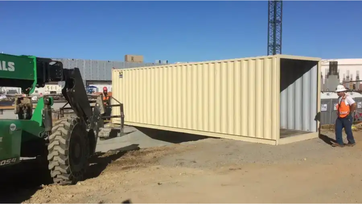 Transporting a shipping container on a site