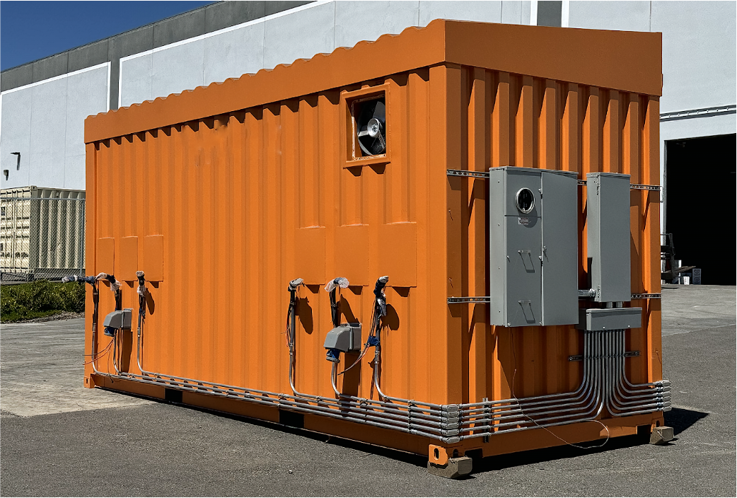 A bright orange shipping container fitted with multiple electrical panels and conduit piping on the exterior.