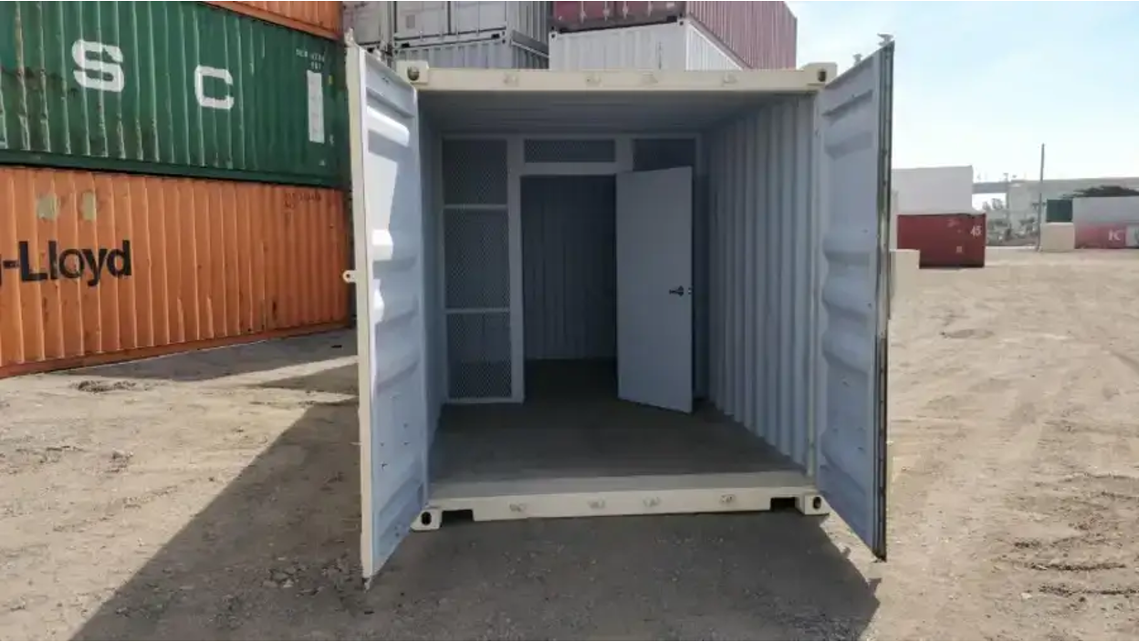 Steel partition wall inside a shipping container office with storage