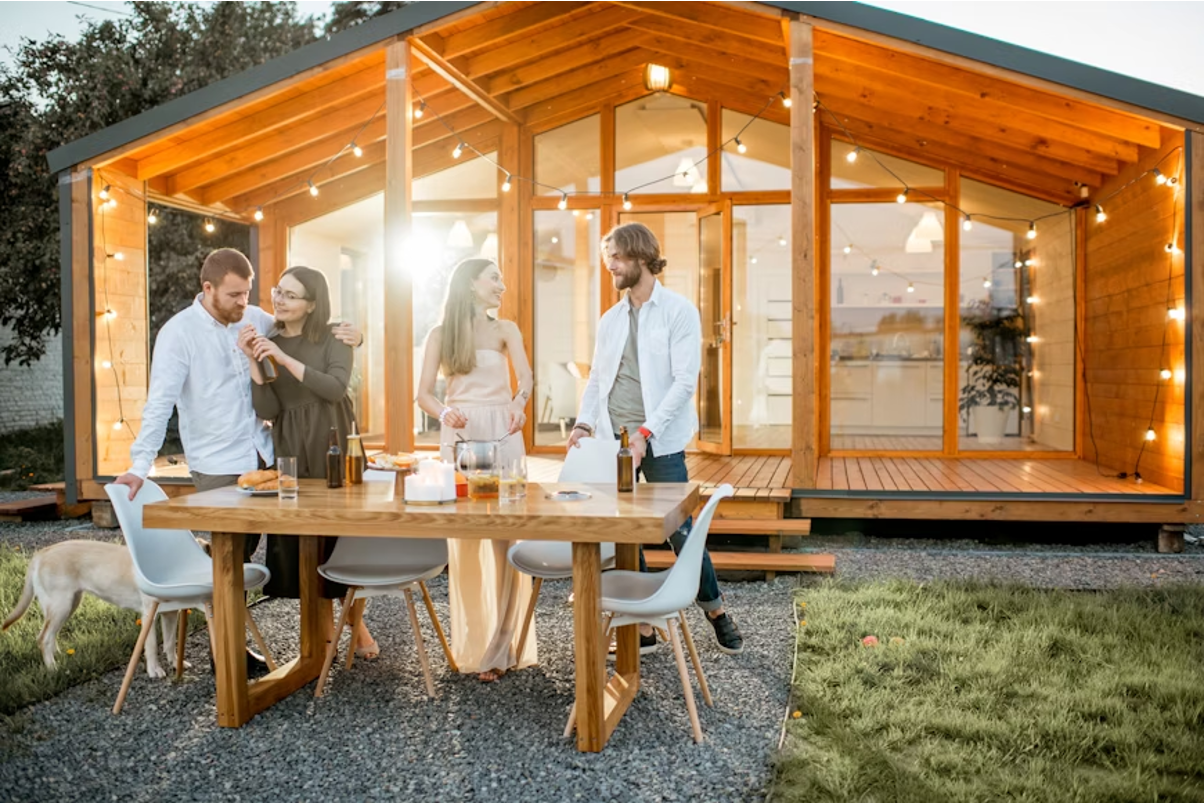 A family at the front of their container home. 