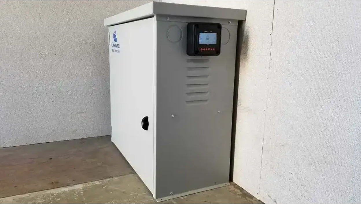 A gray solar power control unit mounted on the side of a wall.