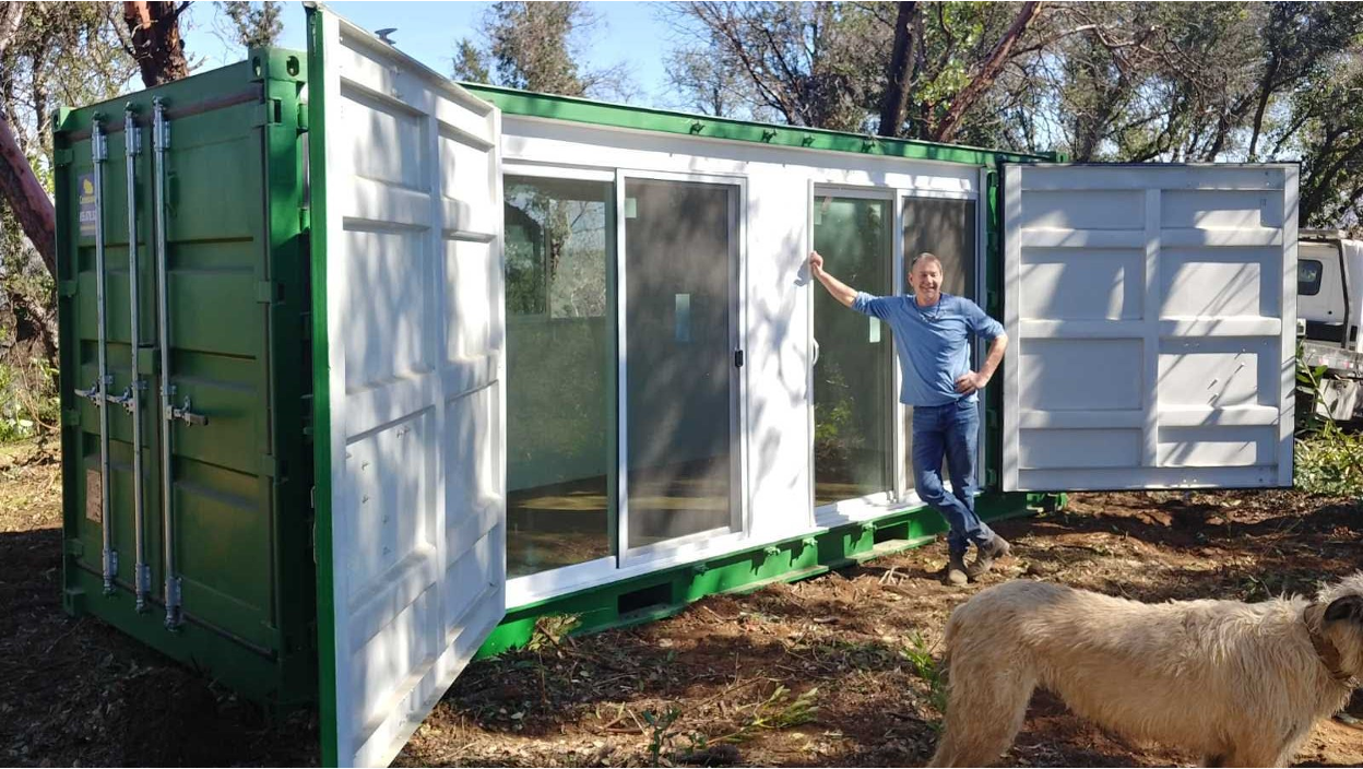 A man leaning on a container at a site