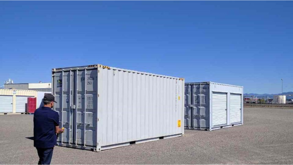 A man moving towards Conexwest’s shipping container inventory. 