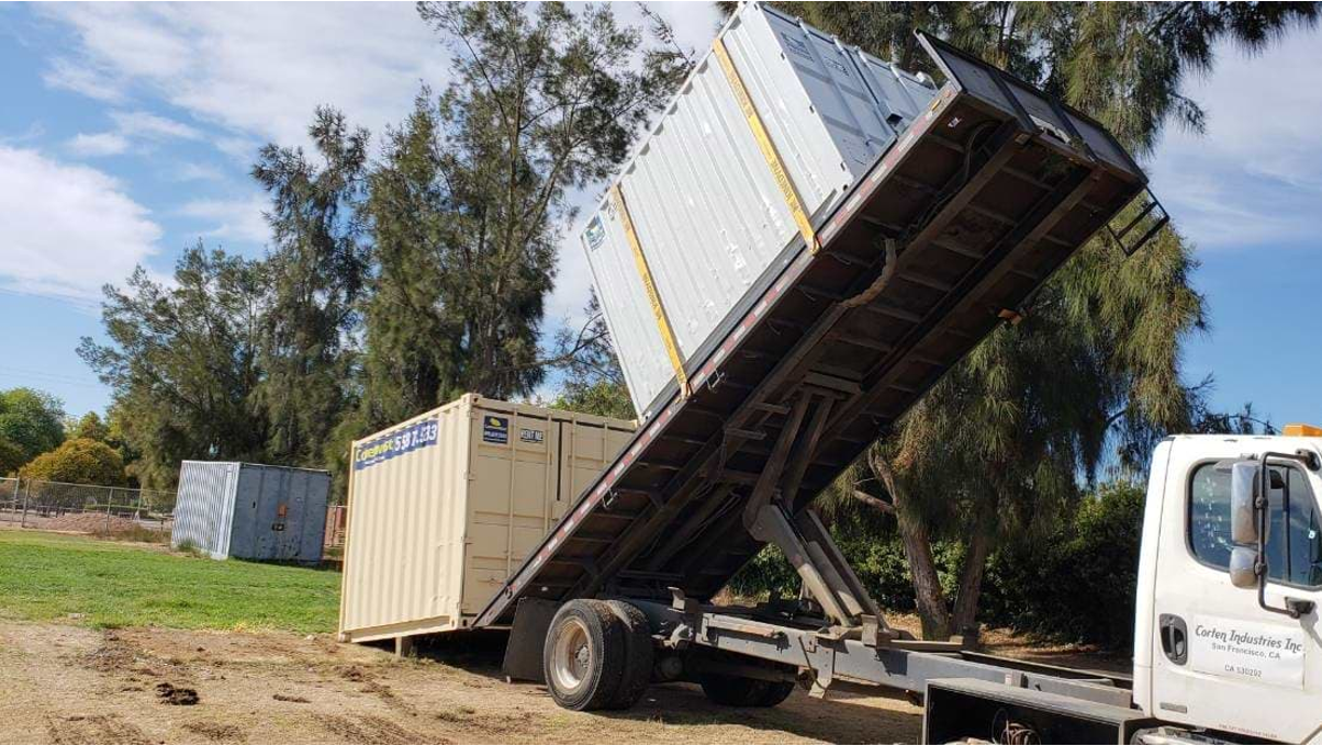 A trailer delivering a container. 