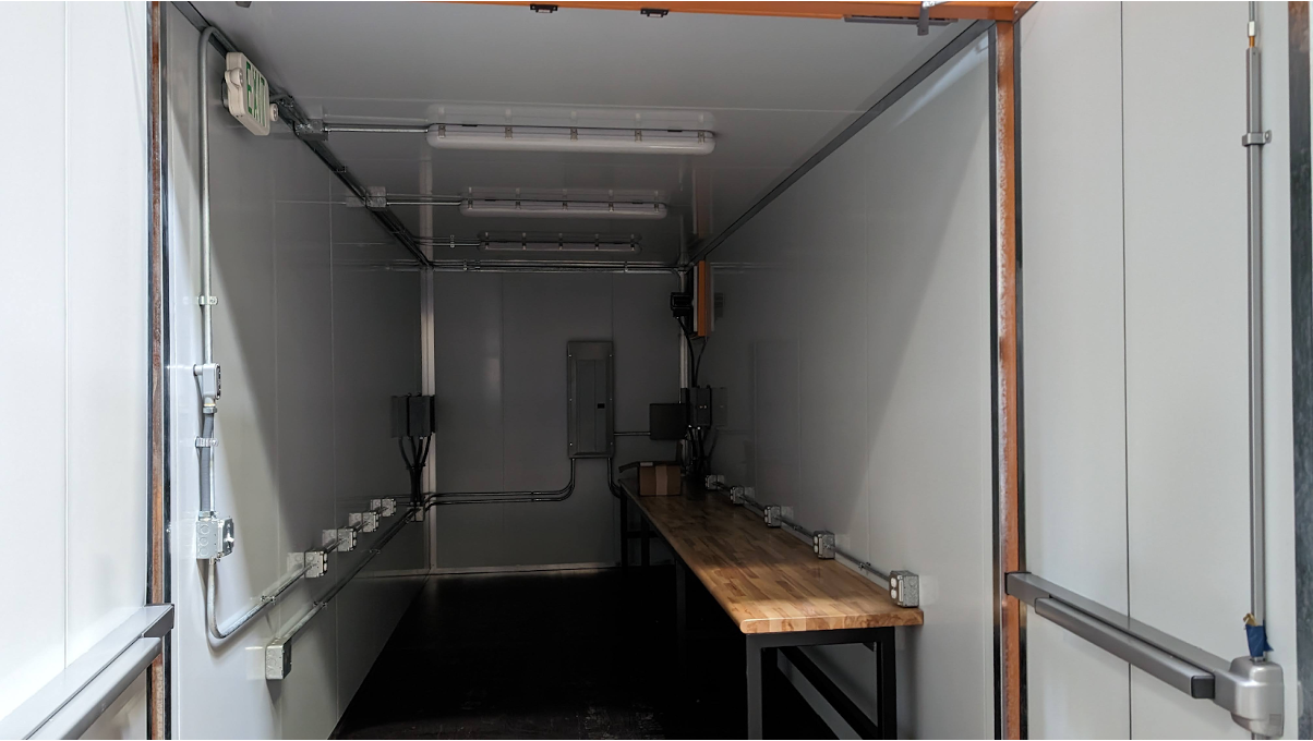 An interior of a shipping container office. 