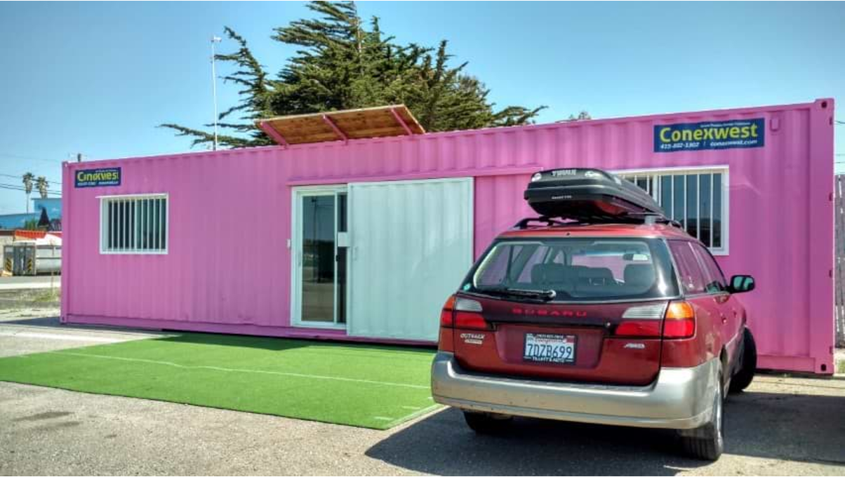 An office container space with a car parked outside.&nbsp; 