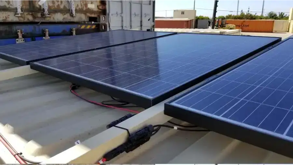 Close-up view of solar panels installed on the roof of a shipping container.