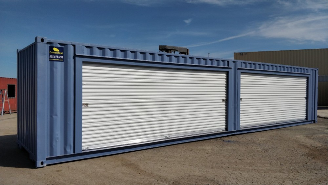Conexwest modified blue shipping container with two large white roll-up doors, situated on a concrete surface.
