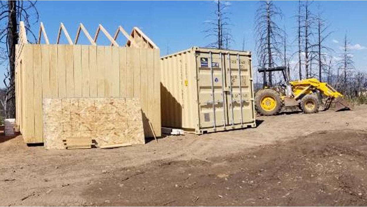 Construction site with a container in the background.