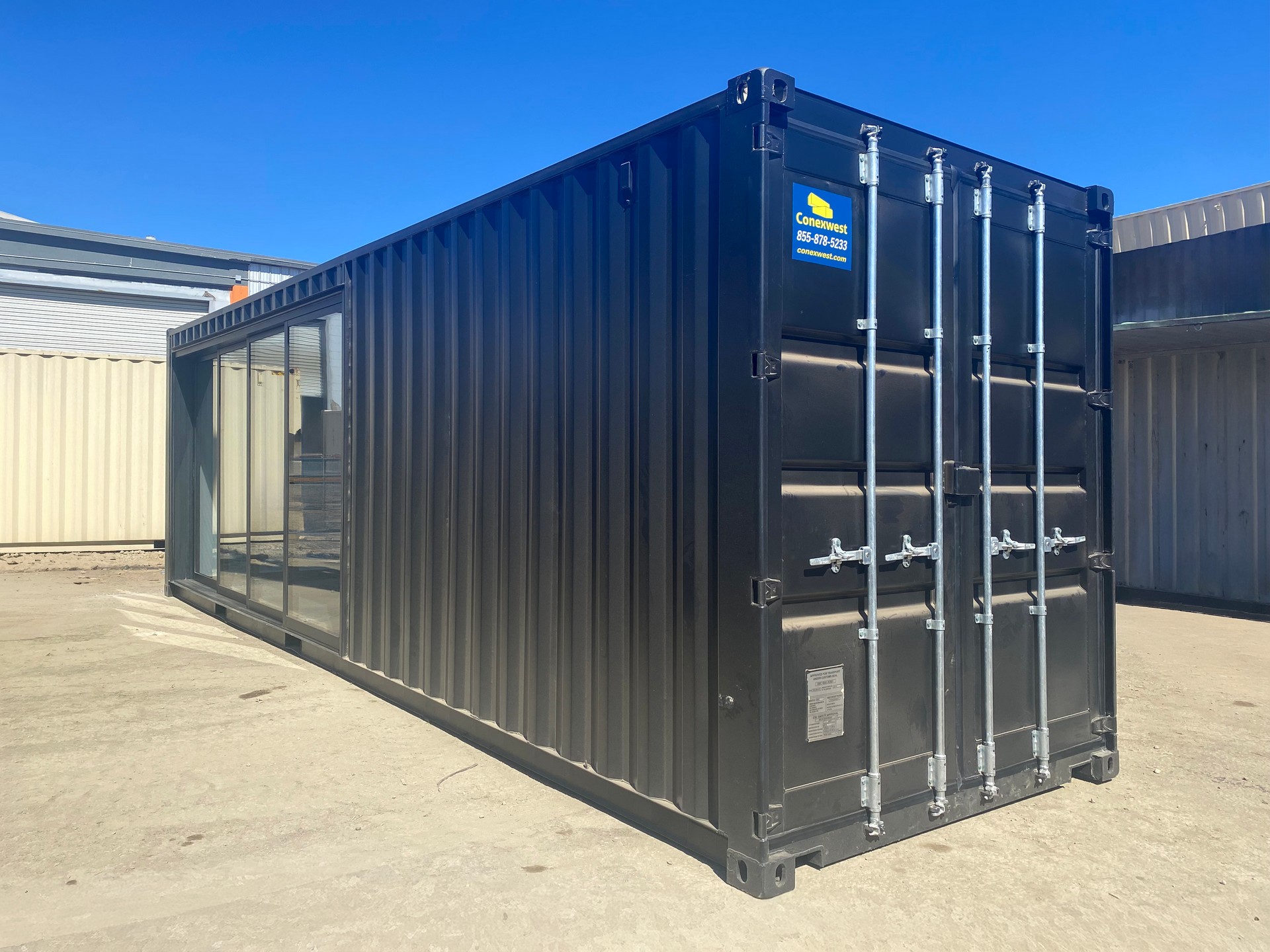 Interior of a custom shipping container storefront with white wall panels and LED lighting