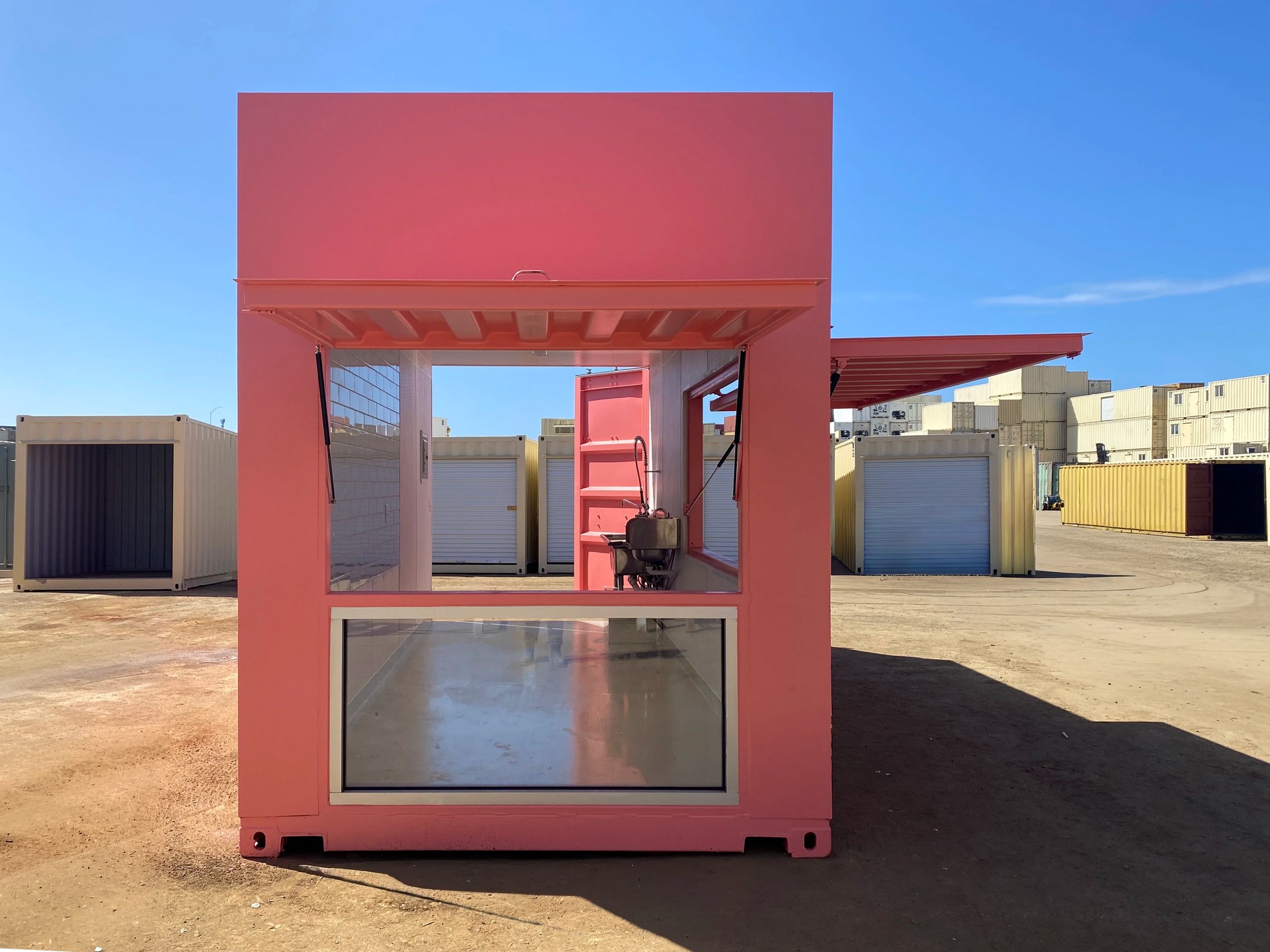 Custom shipping container cafe interior with sink, lighting, and service-ready layout