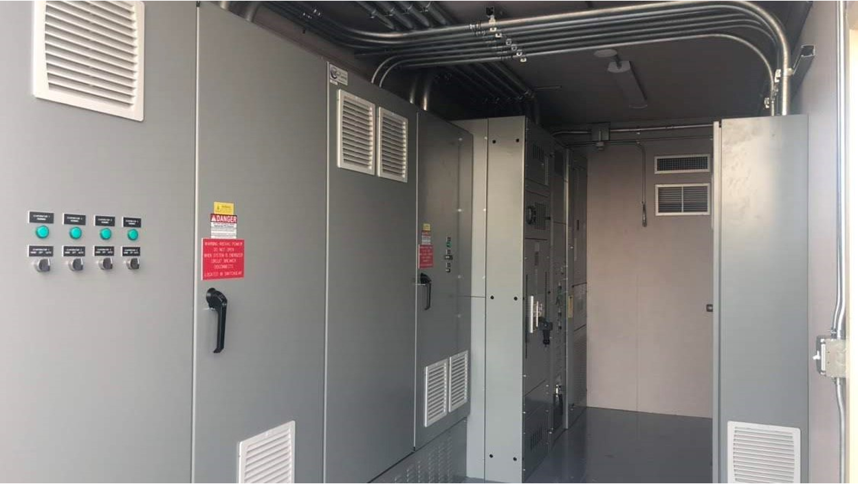 Interior of a modified container bunker showing electrical panels, ventilation, and wiring.