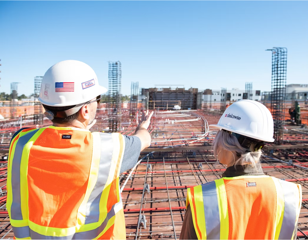 Two building inspectors reviewing construction