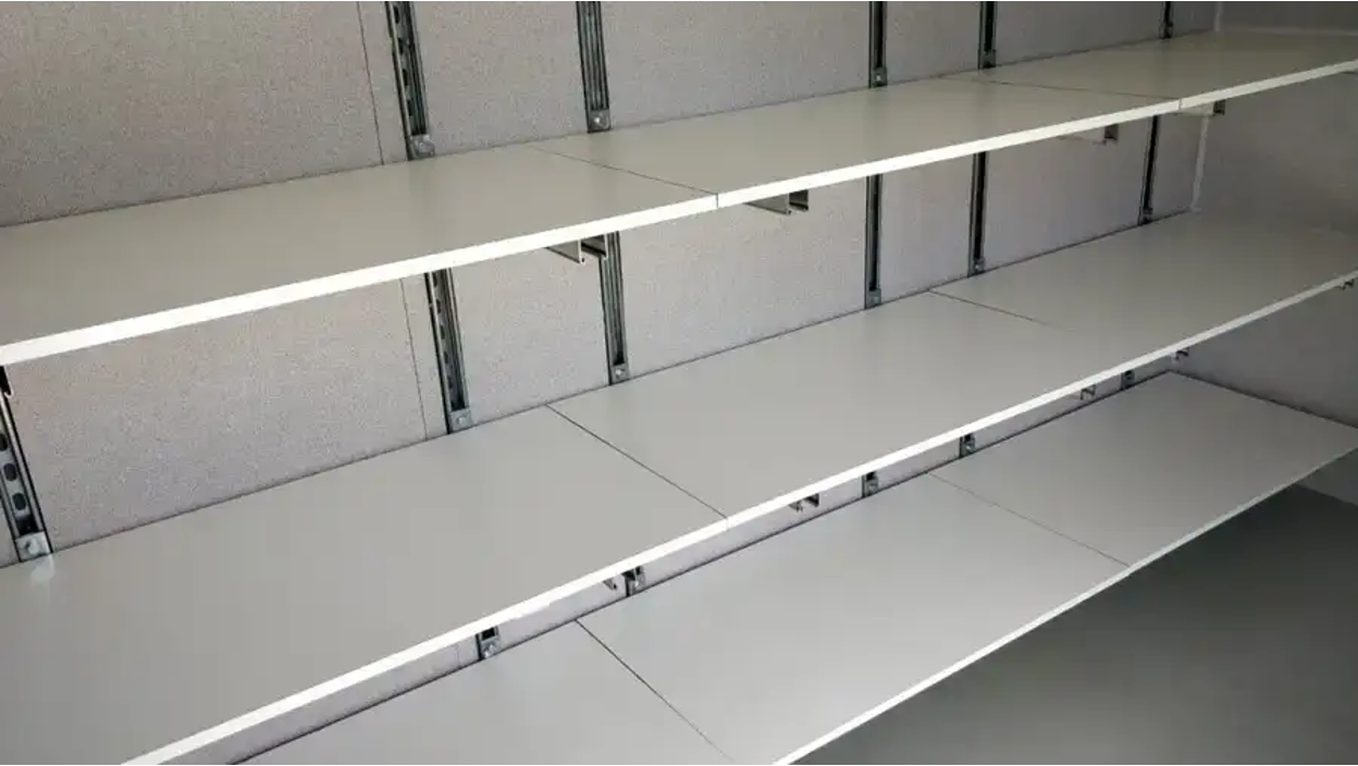 Unistrut adjustable shelving for shipping containers.