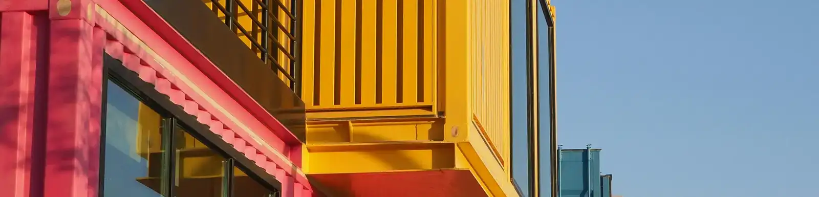 Photo by Natalya Rostun: https://www.pexels.com/photo/vibrant-shipping-container-architecture-in-doha-35070703/